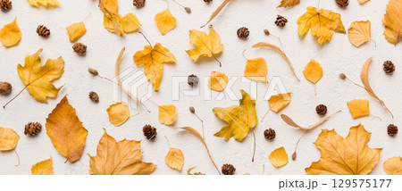 Autumn composition. Pattern made of dried leaves and other design accessories on table. Flat lay, top view Autumn composition. Pattern made of dried leaves and other design accessories on table. Flat lay, top view 129575177