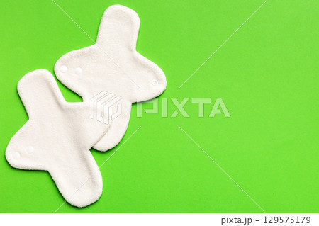 Eco-friendly reusable fabric women's pads. set of colorful bright reusable menstrual pads. zero waste woman periods concept top view with copy space Eco-friendly reusable fabric women's pads. set of colorful bright reusable menstrual pads. zero waste woman periods concept top view with copy space 129575179