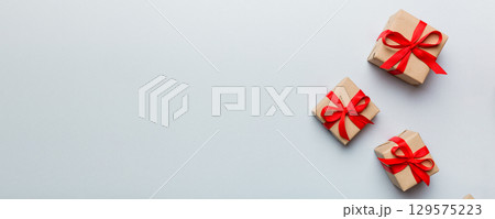 Valentine day composition: red gift box with bow and heart. Christmas present. View from above. Space for text. Holday greeting card 129575223