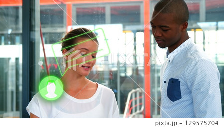 Image of person icon and speech bubble over diverse male and female colleague talking in office 129575704