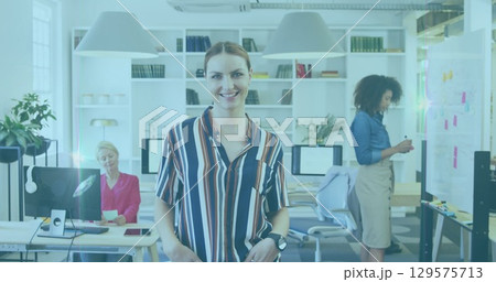 Image of flared light over portrait of happy businesswoman with diverse coworkers in office Image of flared light over portrait of happy businesswoman with diverse coworkers in office 129575713