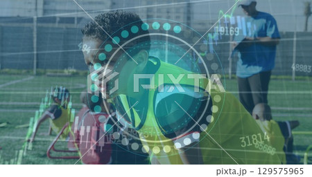 Image of scope scanning and data processing over boy football player on pitch 129575965