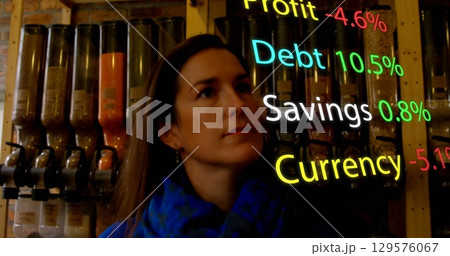 Image of financial data processing over caucasian woman at grocery 129576067