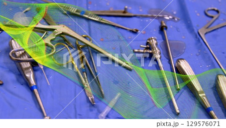Image of green shapes over surgical instruments 129576071