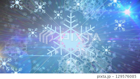 Large central snowflake floating in winter art, with light rays scattering translucent snowflakes 129576085