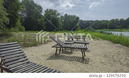 Summer river landscape with green trees, reflections and blue sky. Tourism Summer river landscape with green trees, reflections and blue sky. Tourism 129576250