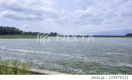 Summer river landscape with green trees, reflections and blue sky. Tourism Summer river landscape with green trees, reflections and blue sky. Tourism 129576251