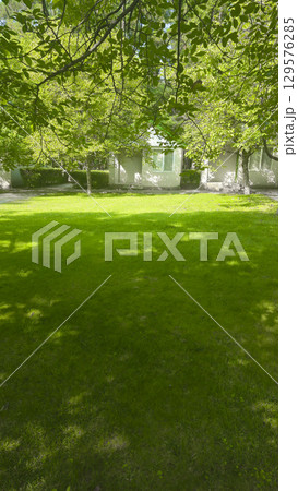 Plot with decorative grass and white houses for recreation. Tourist recreation. 129576285