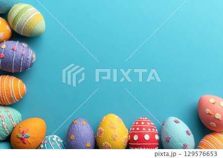 Decorated Easter eggs and space for text on color background, top view 129576653