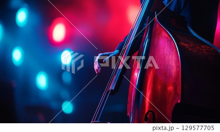 A musician plays a double bass under vivid stage lights. The vibrant colors create a dynamic atmosphere. Music comes alive through artistry and passion. Generative AI 129577705