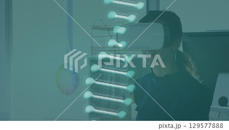 Image of dna structure spinning over caucasian woman wearing vr headset at office 129577888