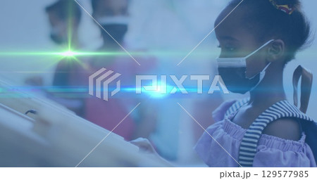 Image of green and blue light spot moving over african american girl wearing face mask at school Image of green and blue light spot moving over african american girl wearing face mask at school 129577985