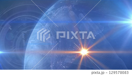 Image of light spots and round scanner over globe and hand icon against blue background 129578083