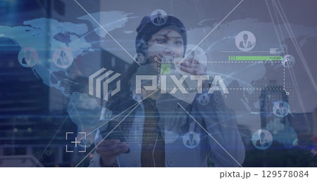 Image of data processing over world map against asian woman having a snack on the street 129578084