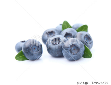 Sweet blueberries with leaves on white backgrounds Sweet blueberries with leaves on white backgrounds 129578479