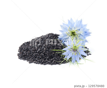 Black cumin seed and nigella flower on white backgrounds 129578480