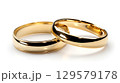 Two golden wedding rings cut out. on white 129579178