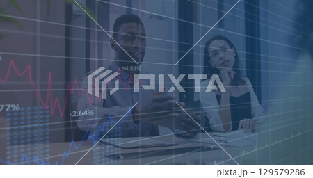 Image of financial graphs and data over diverse businesspeople in office Image of financial graphs and data over diverse businesspeople in office 129579286
