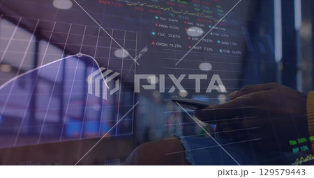 Image of financial data and graphs over hands of caucasian man using smartphone Image of financial data and graphs over hands of caucasian man using smartphone 129579443