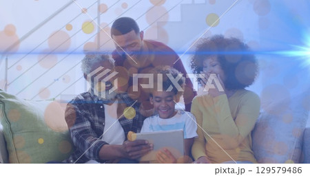 Image of dots moving over happy african american multi generation family using tablet 129579486