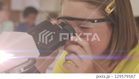 Image of light trails over caucasian schoolgirl using microscope Image of light trails over caucasian schoolgirl using microscope 129579567