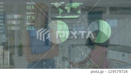 Image of data processing over diverse businesswomen in office 129579726