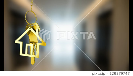 Image of golden house keys hanging against blurred background with copy space 129579747