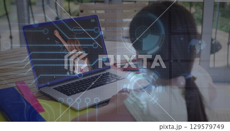 Image of round scanner and microprocessor connections against girl having a image call on laptop 129579749