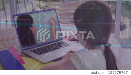 Image of data processing over rear view of girl wearing face mask having a image call on laptop Image of data processing over rear view of girl wearing face mask having a image call on laptop 129579767
