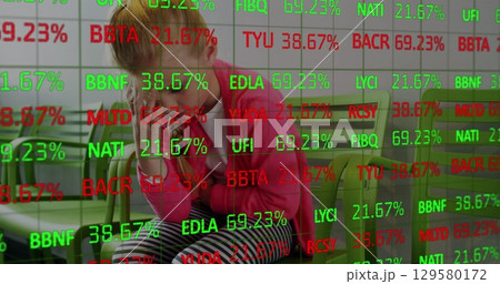 Image of financial data over sad caucasian girl waiting in hospital 129580172