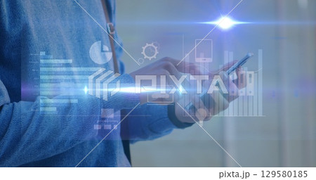 Image of flare with graphs and computer icons over midsection of man using smartphone 129580185