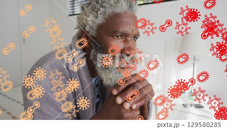 Image of virus cells moving over thoughtful bearded senior man with hands clasped sitting on bed 129580285