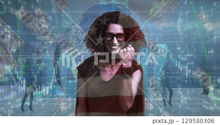 Image of financial data processing and american dollar bills over caucasian super hero woman 129580306