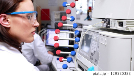 Image of dna strand over diverse doctors in lab 129580388