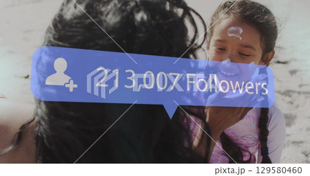 Image of increasing followers over mother and daughter playing at the beach Image of increasing followers over mother and daughter playing at the beach 129580460