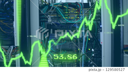 Image of financial data processing with graph and arrows over server room 129580527