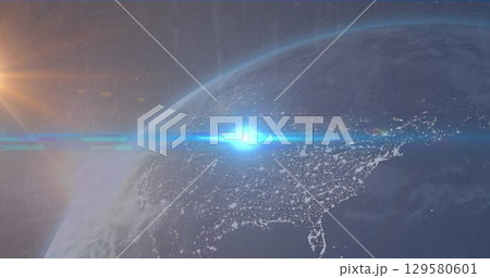 Image of blue light spot over globe against blue background 129580601