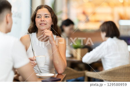 Couple of men and women talking and drinking coffee Couple of men and women talking and drinking coffee 129580959
