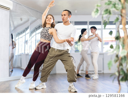 Young men and women dancing latin dances Young men and women dancing latin dances 129581166
