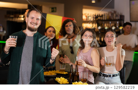 Group of fans in bar with Belgian flag Group of fans in bar with Belgian flag 129582219