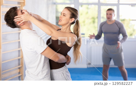 Woman delivers painful blow to eyes of an attacking man - self defense training for women and men Woman delivers painful blow to eyes of an attacking man - self defense training for women and men 129582227