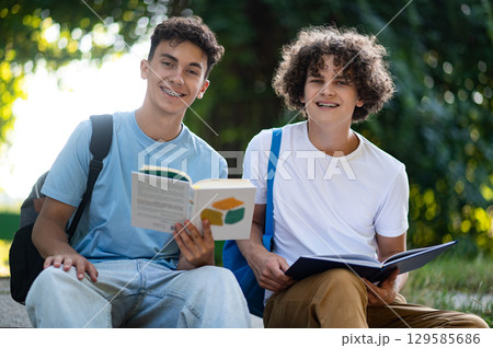 Two friends spending time together in the park after school Two friends spending time together in the park after school 129585686