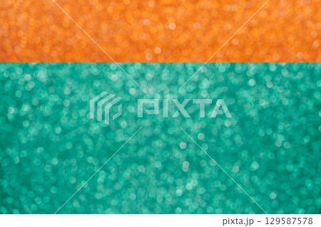 Colorful orange and green glitter large bokeh background Colorful orange and green glitter large bokeh background 129587578