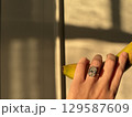 Diamond engagement ring and banana in golden afternoon light 129587609