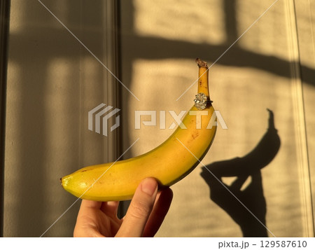 Oval diamond ring and banana with artistic light and shadows Oval diamond ring and banana with artistic light and shadows 129587610