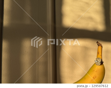 Large oval diamond ring showcased with banana in sunlight Large oval diamond ring showcased with banana in sunlight 129587612