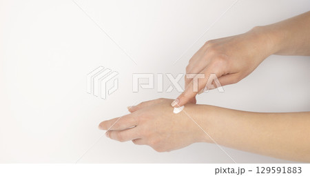 Hand with cream. Gentle female hands. Concept of skin care and cosmetic products. 129591883