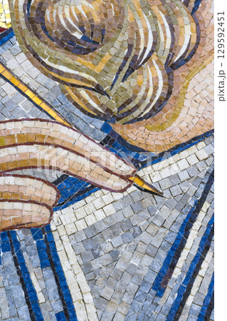 Close-up of Ancient Mosaic Art with Hand and Stylus 129592451