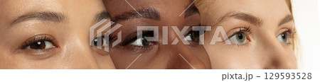 Collage with trio of women eyes in closeup view, each representing different ethnic origins and natural features. Banner Collage with trio of women eyes in closeup view, each representing different ethnic origins and natural features. Banner 129593528