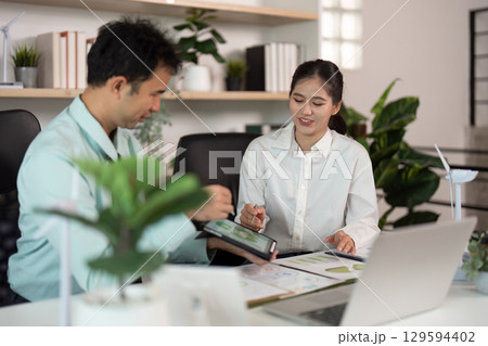 ESG-focused meeting between colleagues in a sustainable workspace 129594402